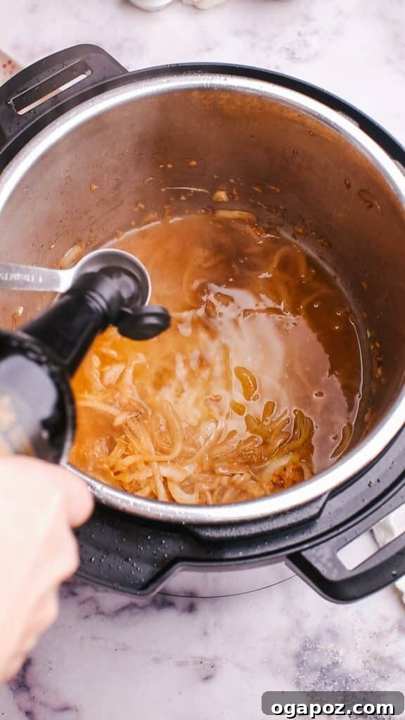 Instant Pot Steak: Fork-Tender Perfection with Savory Pan Sauce 9 Adding sauce mixture to the Instant Pot with steak and aromatics.
