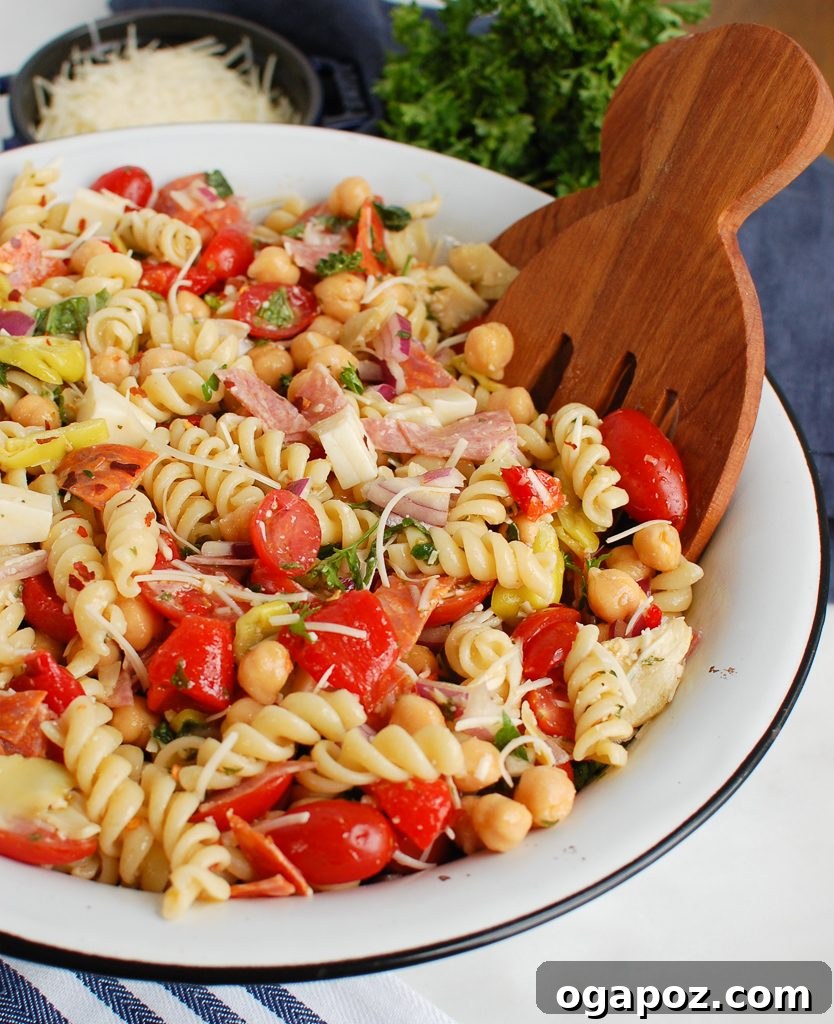 Savory Italian Pasta Medley 2 A large white bowl filled with a colorful Italian Pasta Salad, featuring pasta, vegetables, and meats.