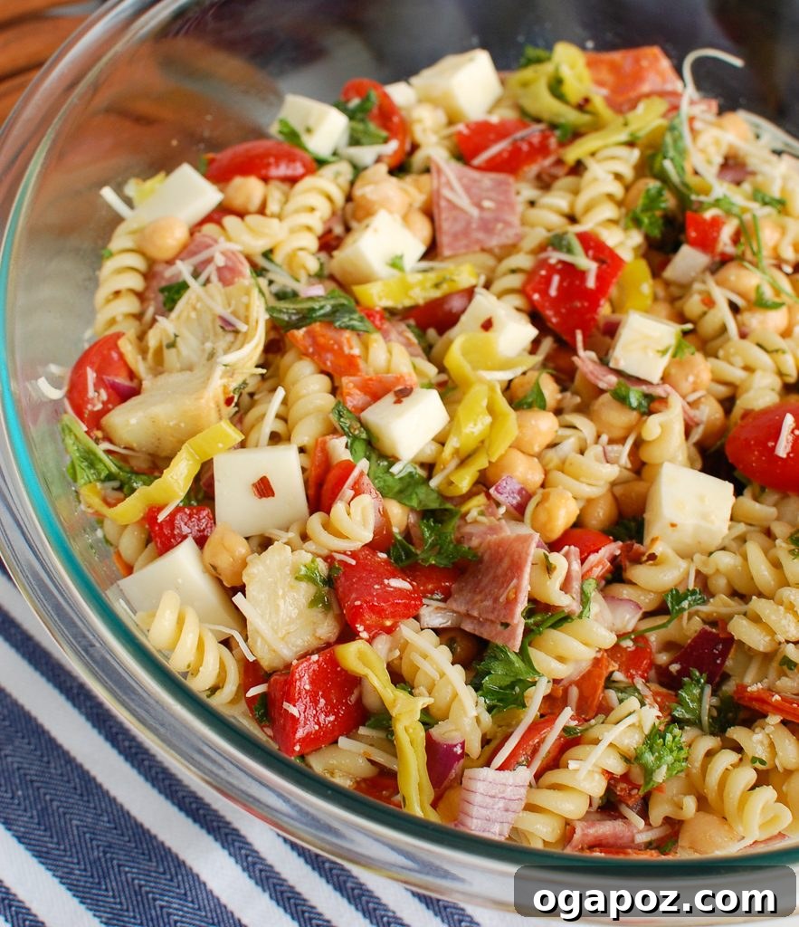 Savory Italian Pasta Medley 4 A glass bowl filled with Italian Pasta Salad, showing the layered ingredients clearly.