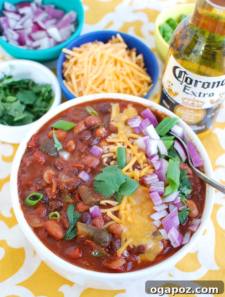 Hearty Slow Cooker Vegetarian Chili 3 Close-up of Slow Cooker Vegetarian Chili in a white bowl, showcasing rich textures and colorful ingredients.