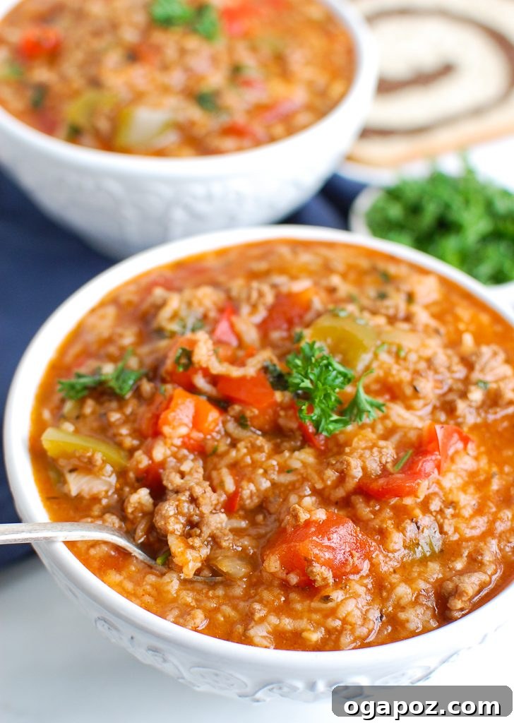 Hearty Instant Pot Stuffed Pepper Soup 2 A steaming bowl of Instant Pot Stuffed Pepper Soup garnished with fresh herbs, ready to be enjoyed.