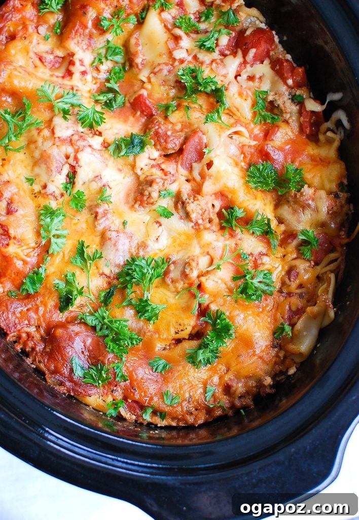 Slow Cooker Lasagna Perfection 3 Slow Cooker Lasagna cooking in Crockpot, showing the rich sauce and cheese layers