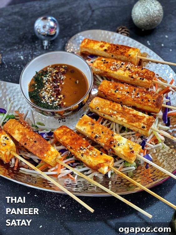 Paneer Perfection: 52+ Recipes for Every Palate 14 Irresistible Thai Paneer Satay skewers, richly marinated and perfectly grilled, presented on a plate.
