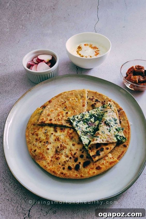 Paneer Perfection: 52+ Recipes for Every Palate 20 Delicious Palak Paneer Paratha, a stuffed Indian flatbread filled with spinach and paneer, served warm.