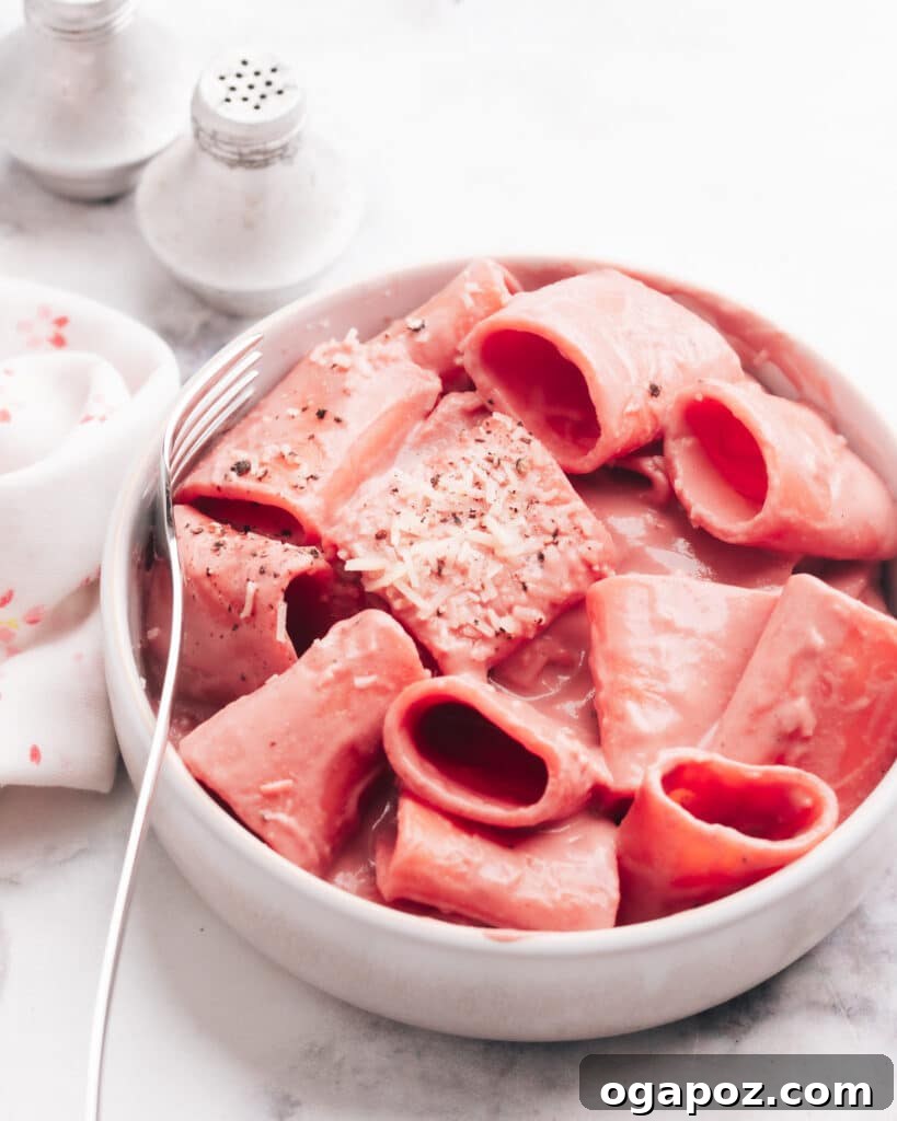 Creamy Beetroot Pasta Delight 3 Delicious pasta in a bowl generously coated with vibrant beet pasta sauce.