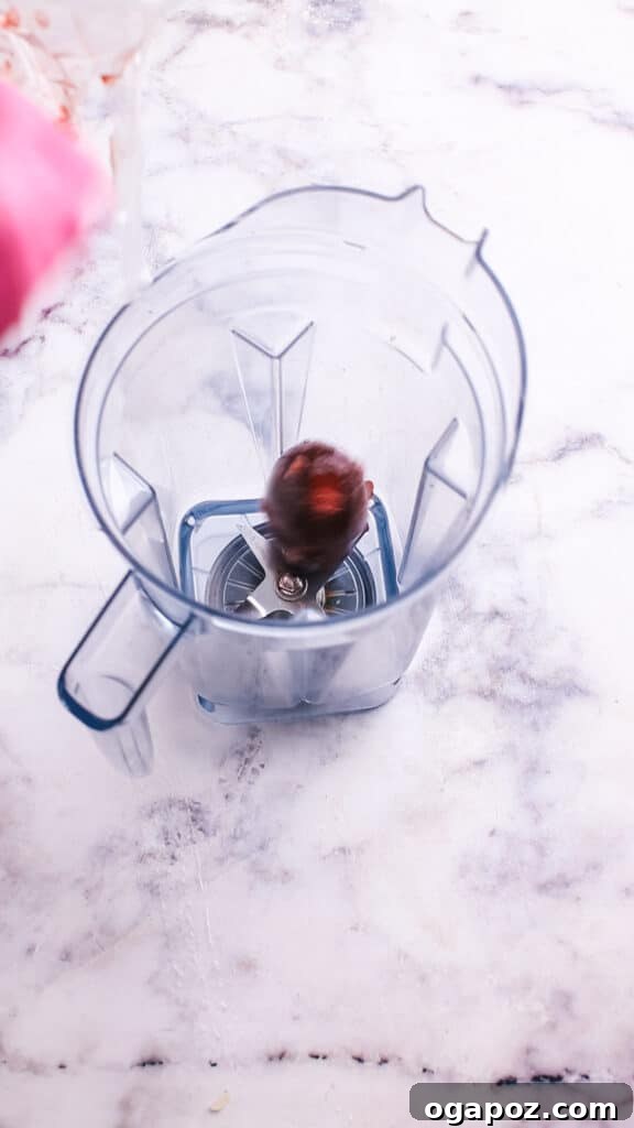 Creamy Beetroot Pasta Delight 5 Adding cooked beets to a blender with broth and sautéed onions.