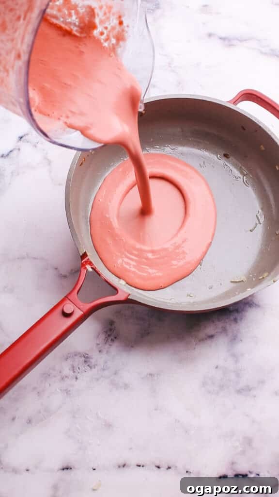 Creamy Beetroot Pasta Delight 10 Returning the pureed beet sauce to the pan to finish cooking.