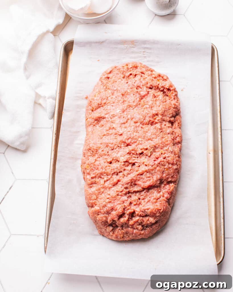 Ultimate Meatloaf Flavor Mix 8 Raw meatloaf mixture shaped and placed in a baking dish, ready for the oven.
