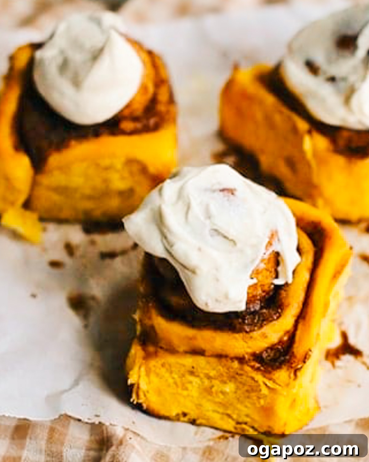 Pumpkin Spice Cinnamon Rolls with Cream Cheese Frosting 2 Pumpkin Cinnamon Rolls with luscious cream cheese frosting, ready to be enjoyed.