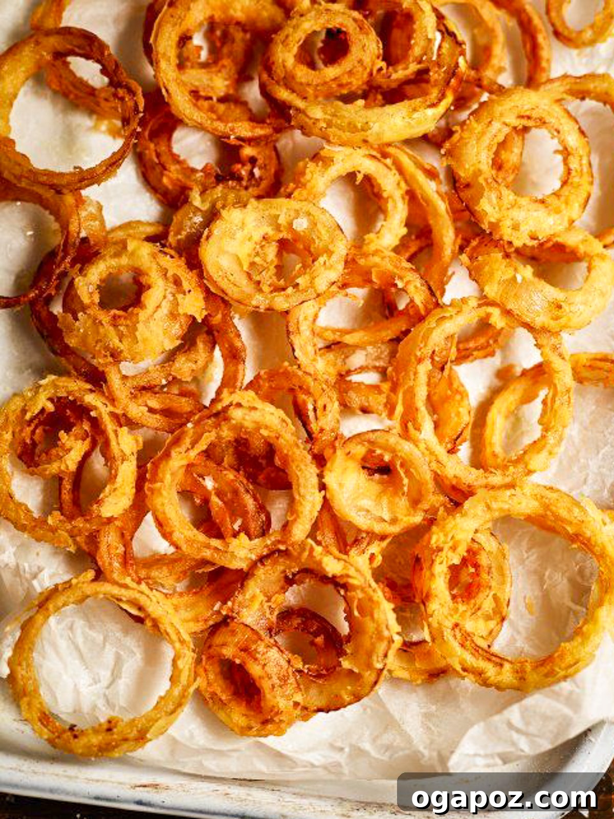 Golden Flaked Crispy Onion Rings 2 Beautifully golden and flaky onion rings served on a tray.