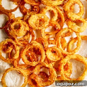 Flaky onion rings on a tray.
