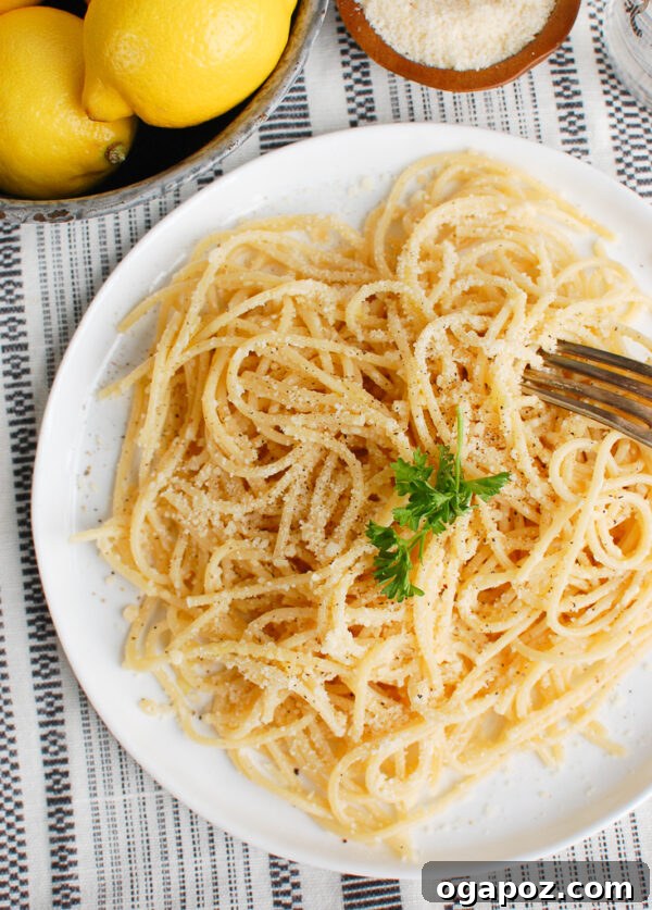 Bright Lemon Pasta 5 Overhead shot of Lemon Pasta with a fork, emphasizing its fresh ingredients.