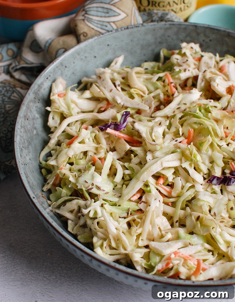 Ultimate Creamy Coleslaw 5 Close-up of creamy coleslaw in a blue bowl, ready to be served.