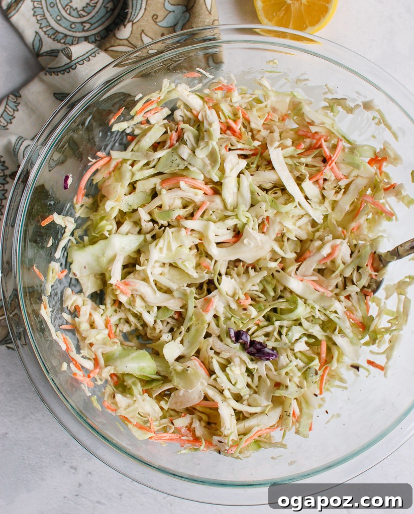 Ultimate Creamy Coleslaw 7 Close-up view of the creamy coleslaw dressing being prepared in a glass bowl.