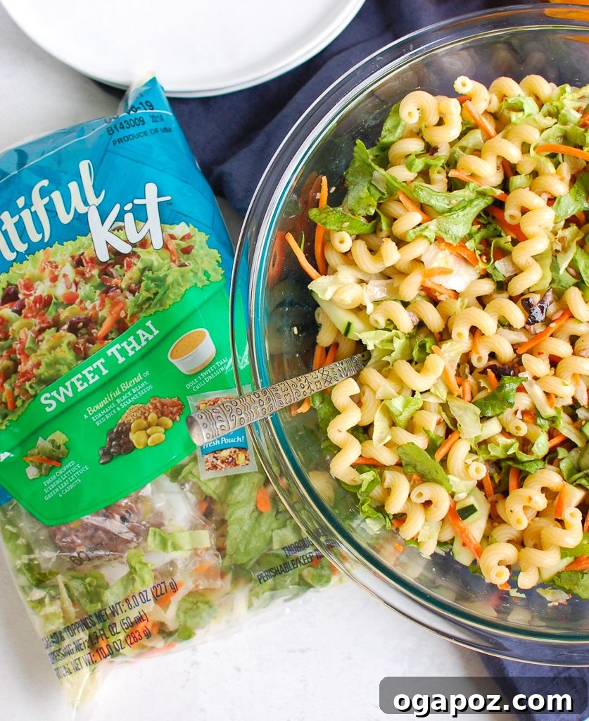 Sesame Ginger Pasta Salad 6 Ingredients for Asian Pasta Salad laid out, including a DOLE salad kit, pasta, and fresh cucumber.