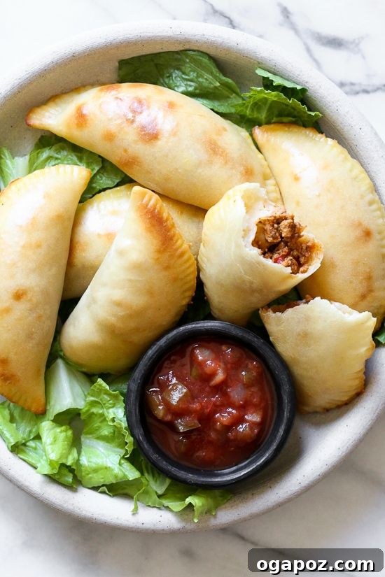 37 Delicious Ways to Enjoy Healthy Ground Turkey 27 Golden-brown Ground Turkey Empanadas on a baking sheet.
