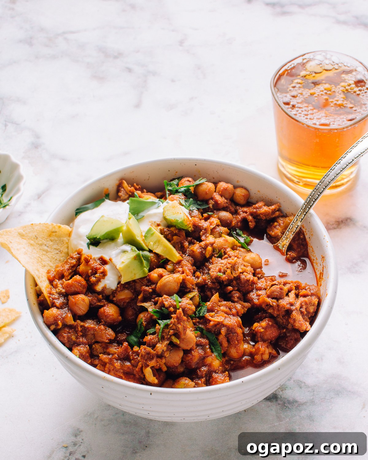 37 Delicious Ways to Enjoy Healthy Ground Turkey 4 Ground Turkey Chili, garnished with fresh cilantro and cheese, in a deep bowl.