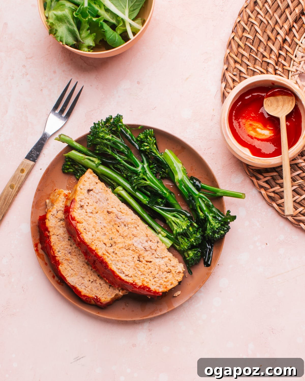 37 Delicious Ways to Enjoy Healthy Ground Turkey 5 Slice of turkey meatloaf with a rich glaze on a white plate, accompanied by a side.