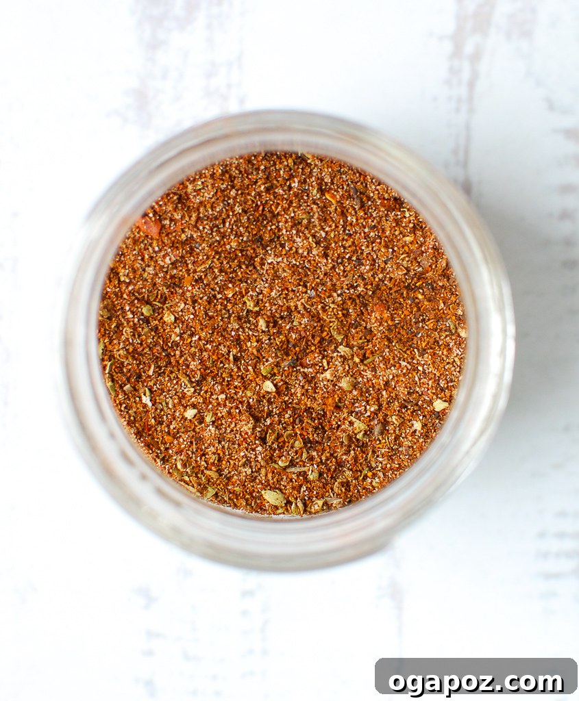 Better-Than-Store-Bought Taco Seasoning 4 Homemade Taco Seasoning Recipe from above, showing the spice blend in a jar with scattered spices