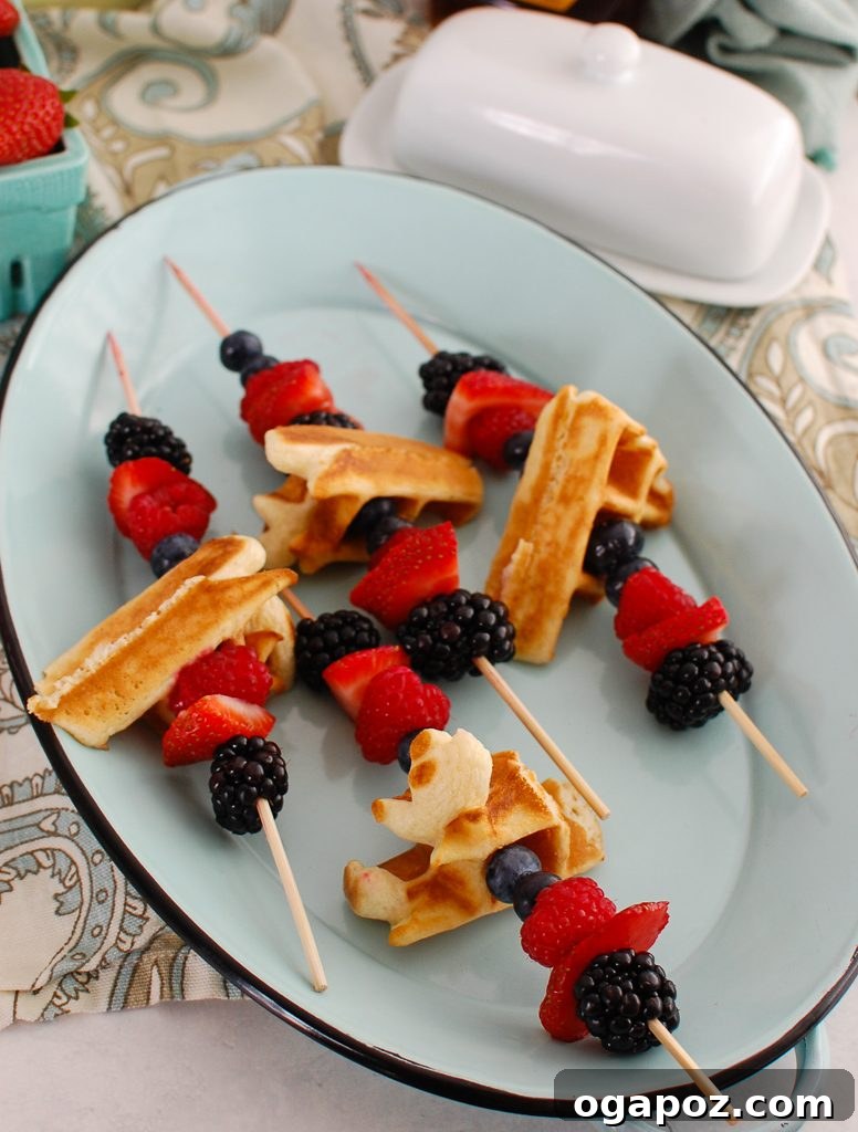 Elevated Greek Yogurt Waffles 3 Close-up of Greek Yogurt Waffles with fresh berries on a teal platter