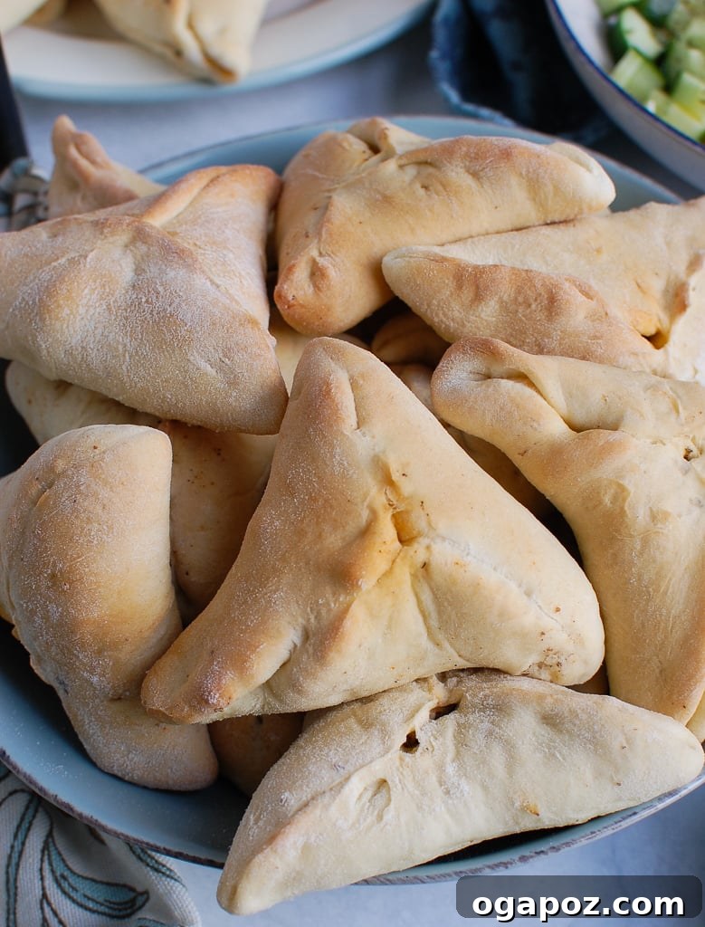 Sfiha: Traditional Lebanese Meat Pies 3 Close-up of freshly baked Lebanese Meat Pies in a bowl, showcasing their golden crust and enticing texture.