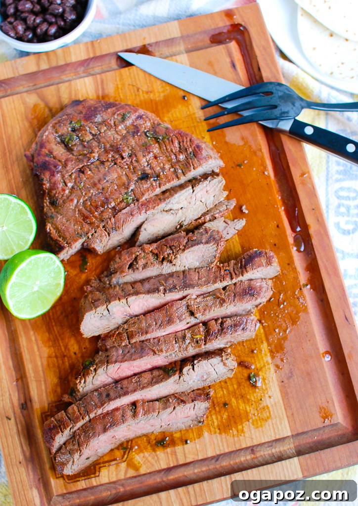 Grilled Carne Asada cooling on a cutting board, ready for slicing