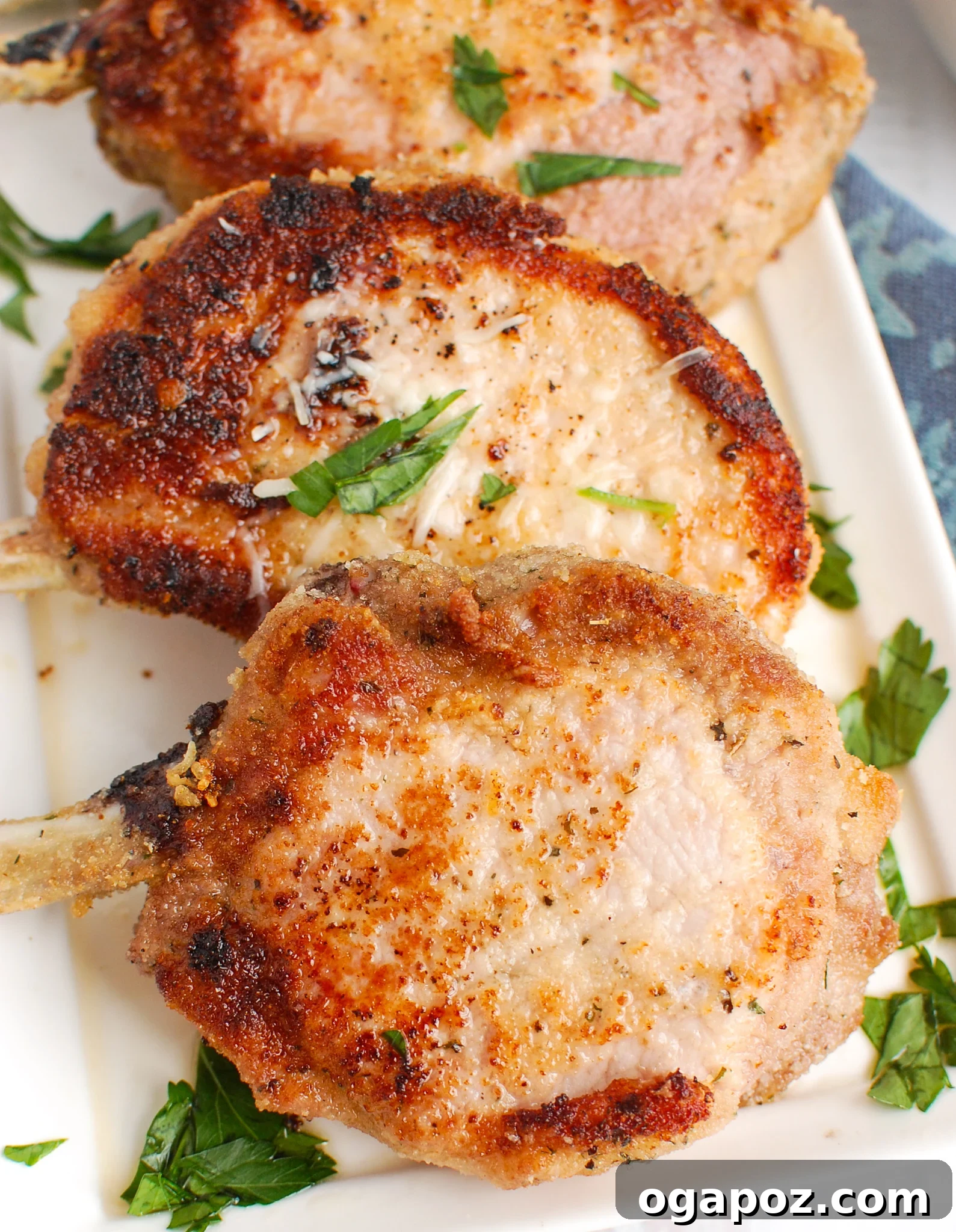 Mastering Tender Oven Baked Pork Chops 6 How to Bake Juicy Pork Chops in the Oven on white platter.