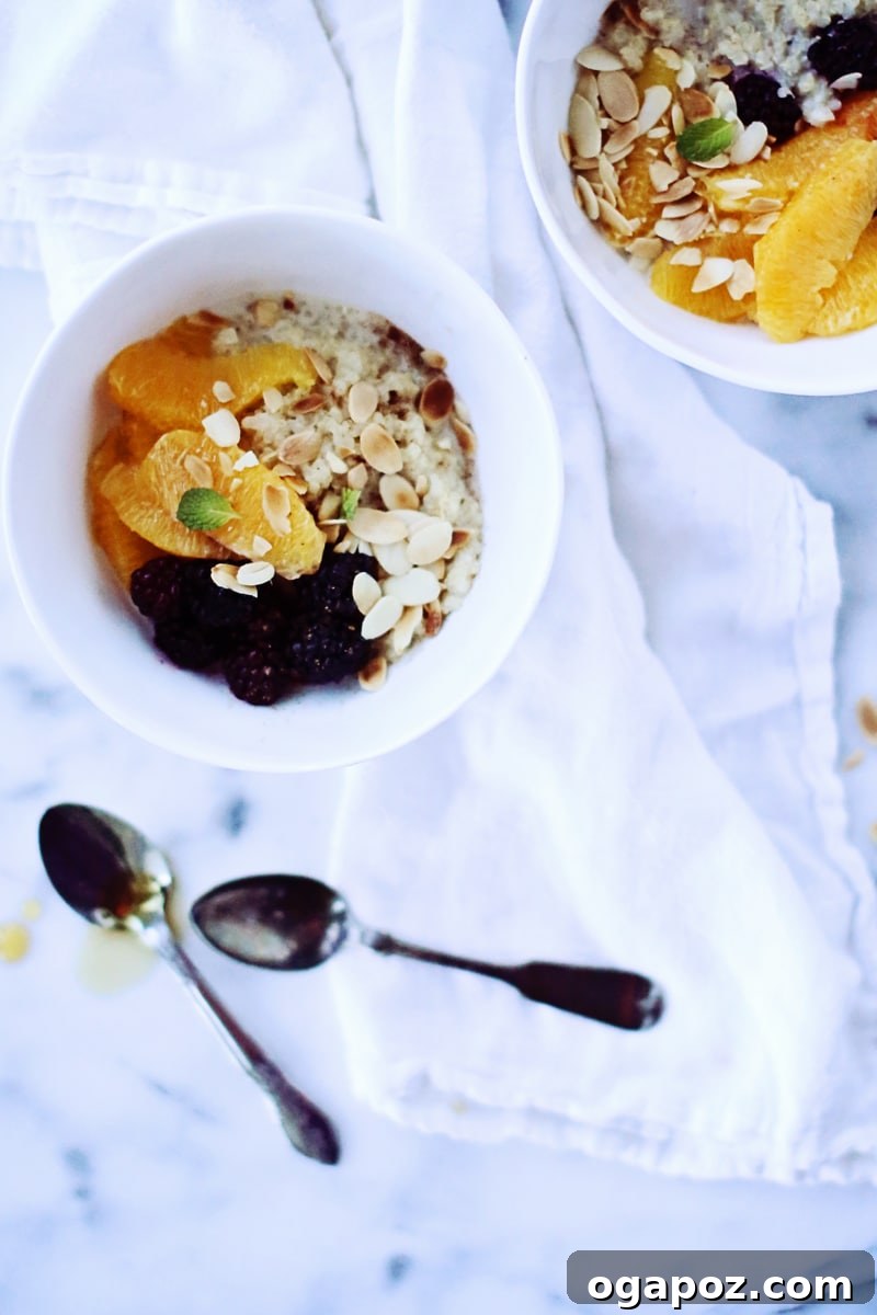 Quinoa Morning Fuel 4 A close-up shot of creamy quinoa porridge in a bowl, generously topped with fresh blueberries, sliced almonds, and a drizzle of maple syrup.