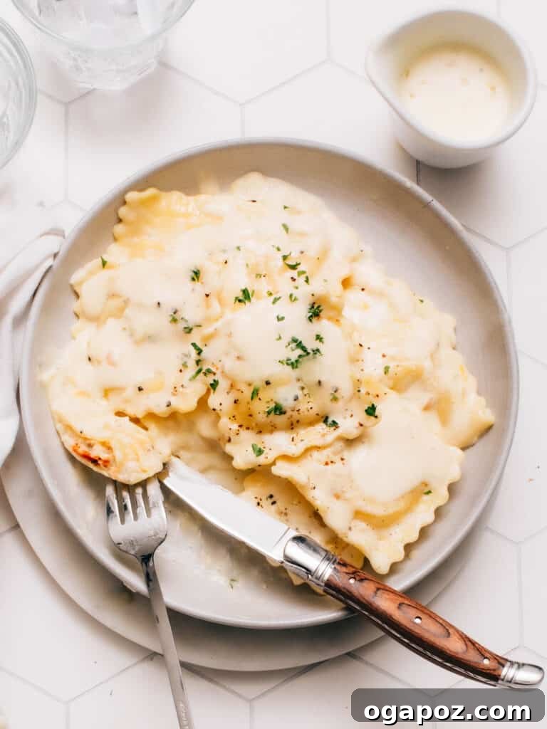 The Secret to Perfectly Cooked Fresh Ravioli 2 Lobster ravioli on a plate with sauce and snipped chives, perfectly cooked and ready to serve.