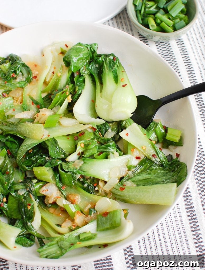 No-Fuss Garlic Bok Choy 2 Easy Bok Choy Recipe served in a white bowl, garnished with fresh green onions