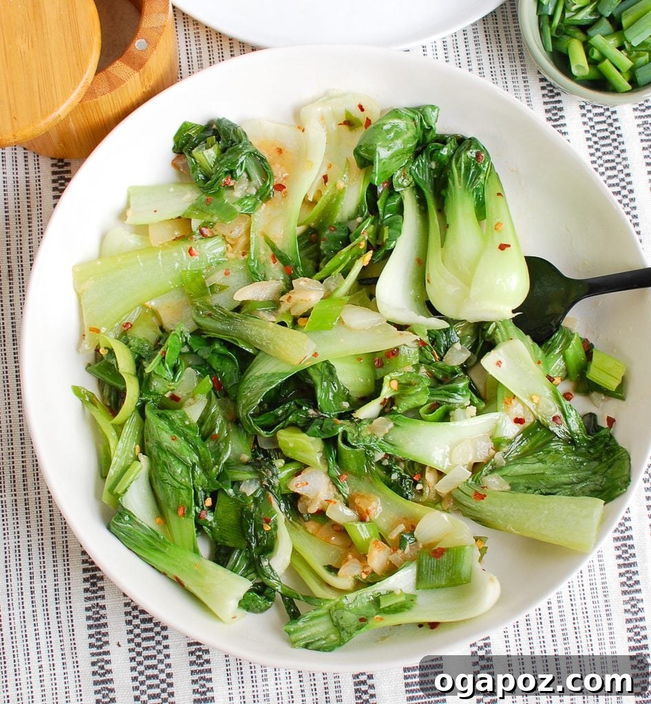 No-Fuss Garlic Bok Choy 4 Overhead shot of Easy Bok Choy Recipe in a white bowl with chopsticks, ready to eat