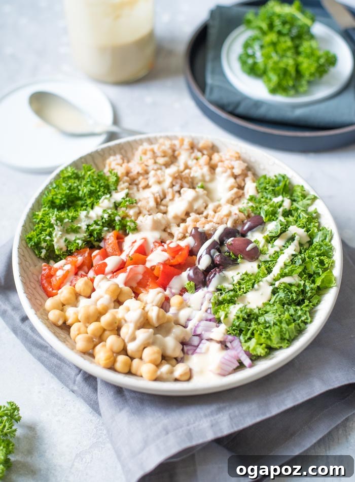 A wholesome Mediterranean Farro Salad with Lemon Tahini Sauce, featuring chewy farro grains mixed with colorful vegetables and drizzled with a creamy tahini dressing.