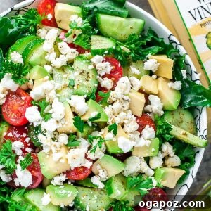 A robust and healthy Greek Kale Salad, featuring massaged kale as a base, combined with classic Greek ingredients like feta cheese, olives, and cherry tomatoes.