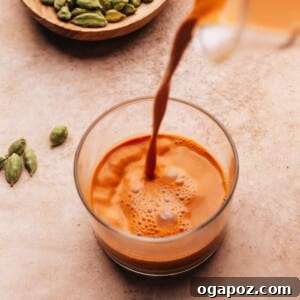 Authentic Karak Chai Made Simple 11 Karak Chai being poured into a glass.