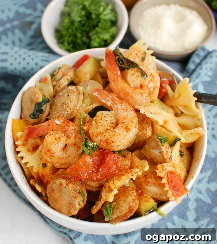 Fiery Cajun Pasta with Chicken Sausage and Shrimp 3 A bowl of creamy Cajun Pasta with Chicken Sausage and Shrimp, garnished with fresh parsley.
