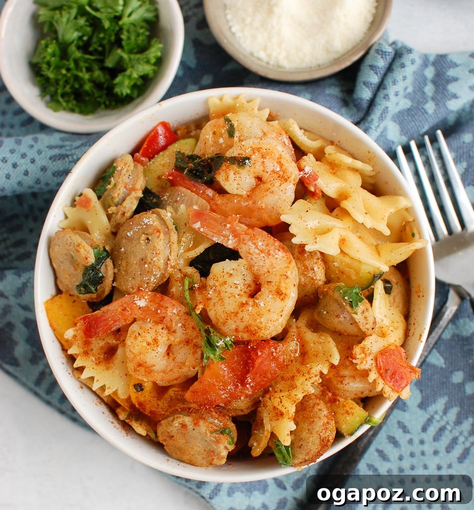 Fiery Cajun Pasta with Chicken Sausage and Shrimp 4 Cajun Pasta with Chicken Sausage and Shrimp served in a white bowl, ready to eat.