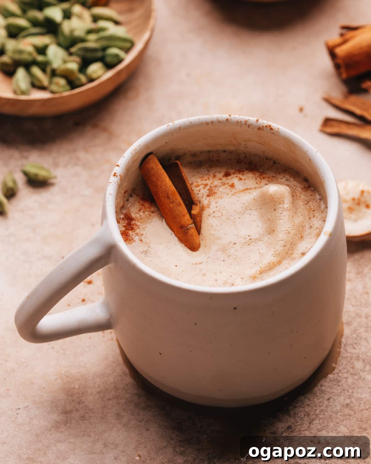 Velvet Froth Chai Coffee Delight 9 Chai coffee with a cinnamon stick in a cup, ready to be enjoyed.