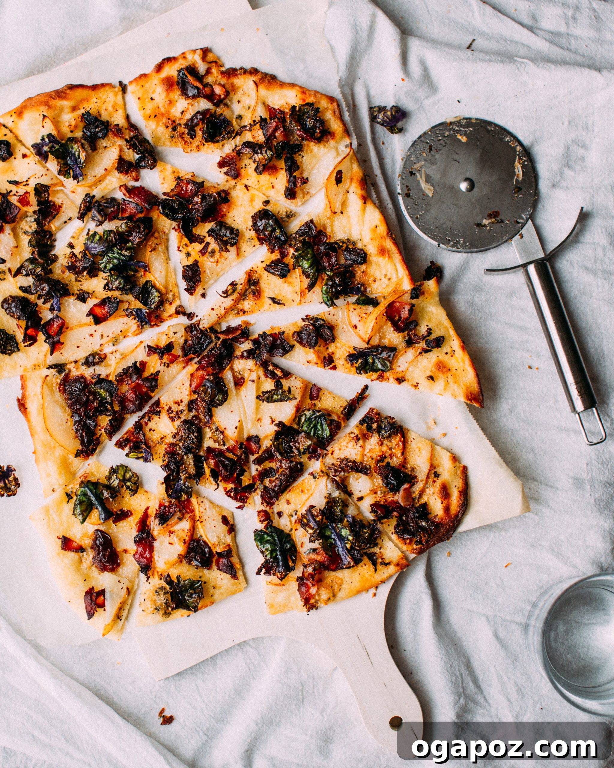 Quick Brussel Sprout Flatbread Bites 5 A beautifully baked Brussels sprout flatbread, cut into slices, showcasing its golden crust and vibrant toppings.