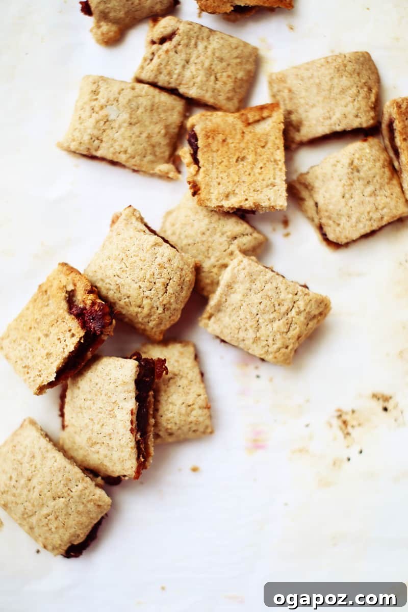 A baby's hand reaching for a healthy homemade fig bar, emphasizing child-friendly snacking and exploration.