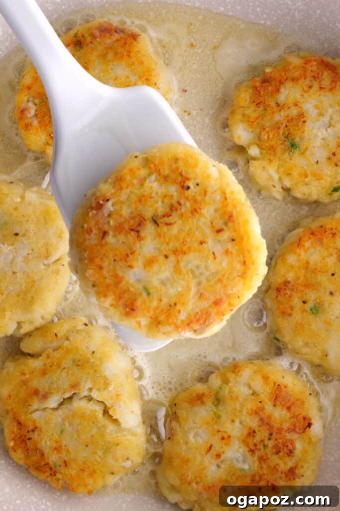Golden Crispy Cod and Potato Patties 8 Close-up of golden brown crispy potato fish cakes with cod, perfectly fried.