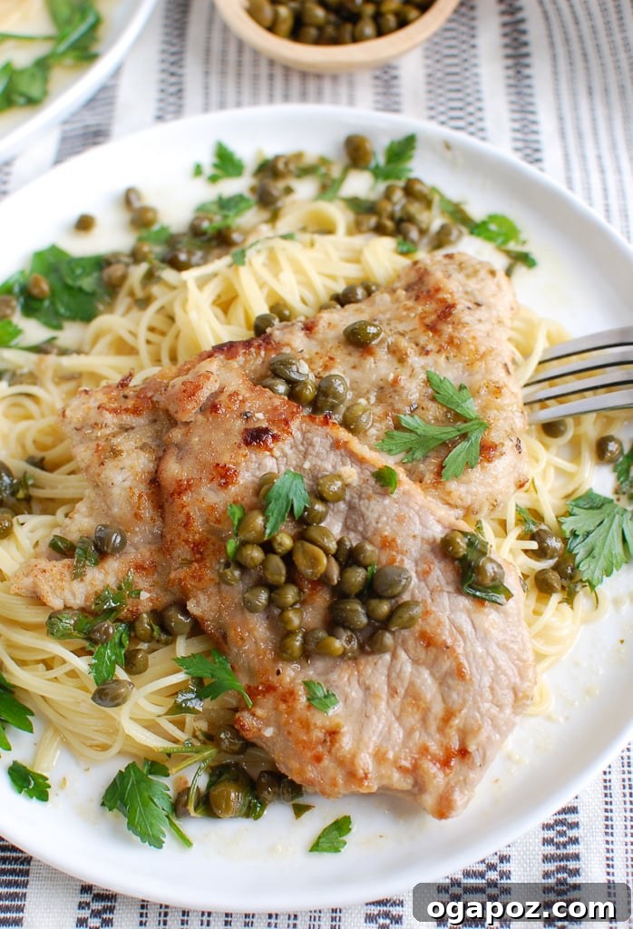 Zesty Lemon Caper Veal 2 Veal Piccata with fork, showing tender veal and rich lemon-butter sauce