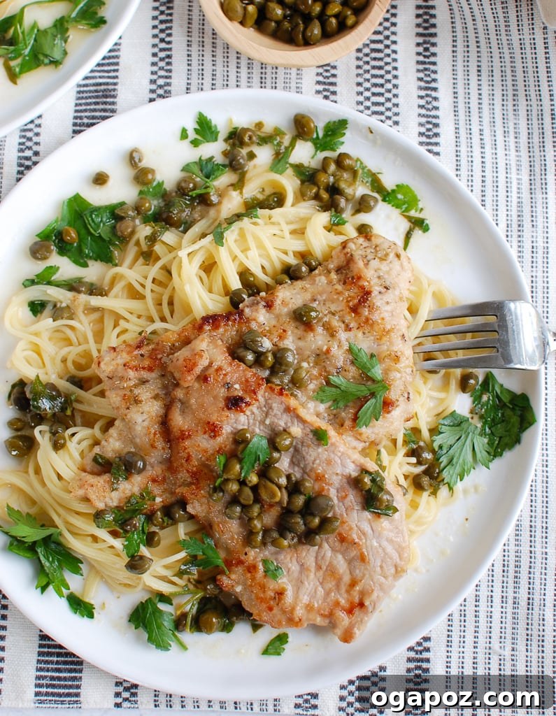 Zesty Lemon Caper Veal 3 Veal Piccata garnished generously with fresh parsley