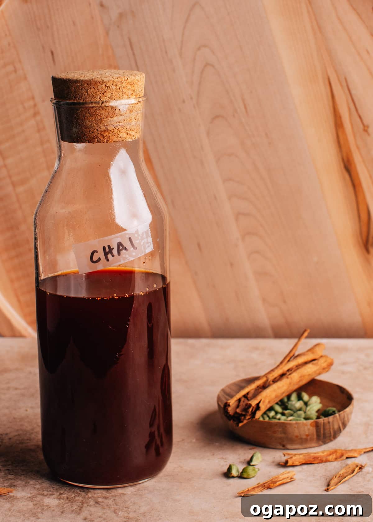 Authentic Chai Concentrate for the Best Homemade Lattes 2 Chai concentrate in a clear glass bottle, showcasing its rich, amber hue, ready to be stored or served. A perfect homemade solution for flavorful beverages.