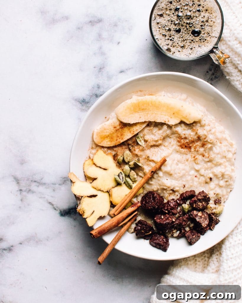 Authentic Chai Concentrate for the Best Homemade Lattes 10 A bowl of creamy oatmeal infused with chai, topped with sliced bananas and a sprinkle of cinnamon, served on a wooden board.