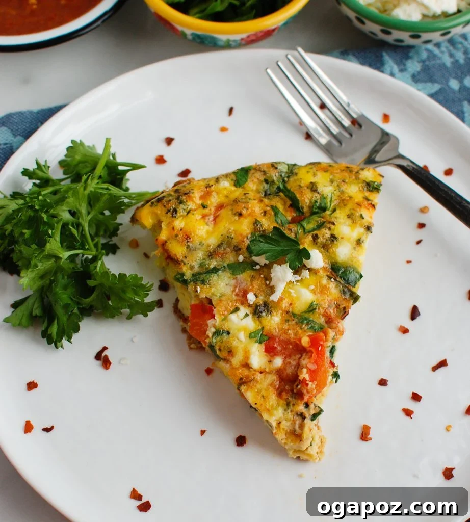 Mediterranean Frittata on a white plate, garnished with fresh herbs
