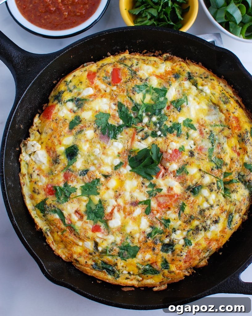 A whole Mediterranean Frittata cooling in a cast iron skillet