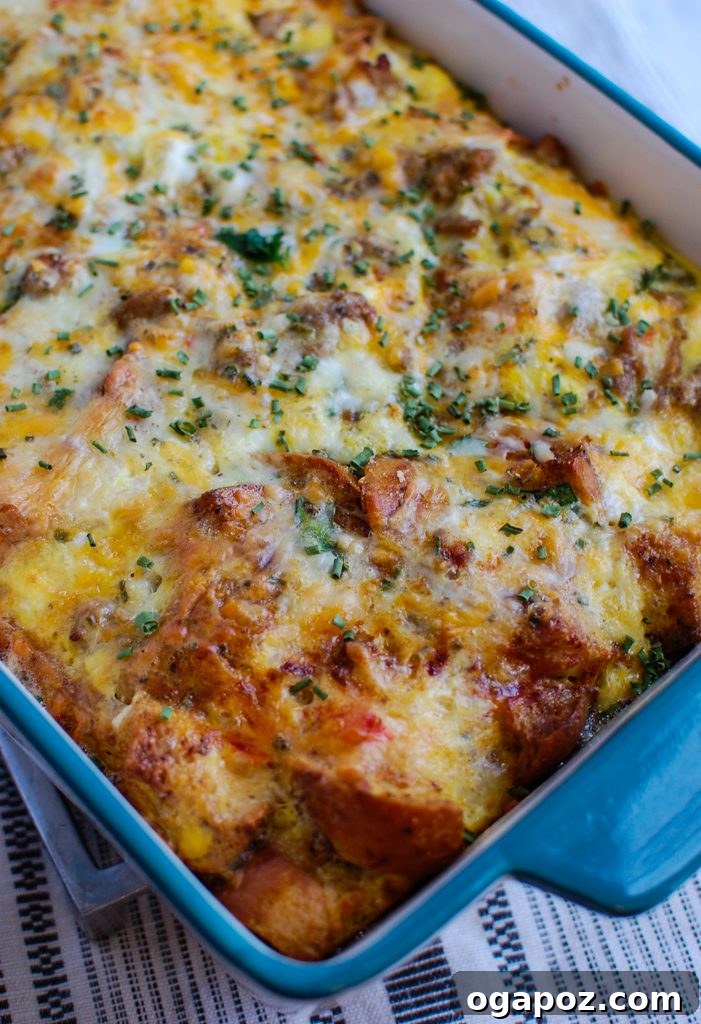 Rise & Shine Sausage Egg Bake 5 A slice of Egg Sausage Casserole being served from a baking dish with a spatula