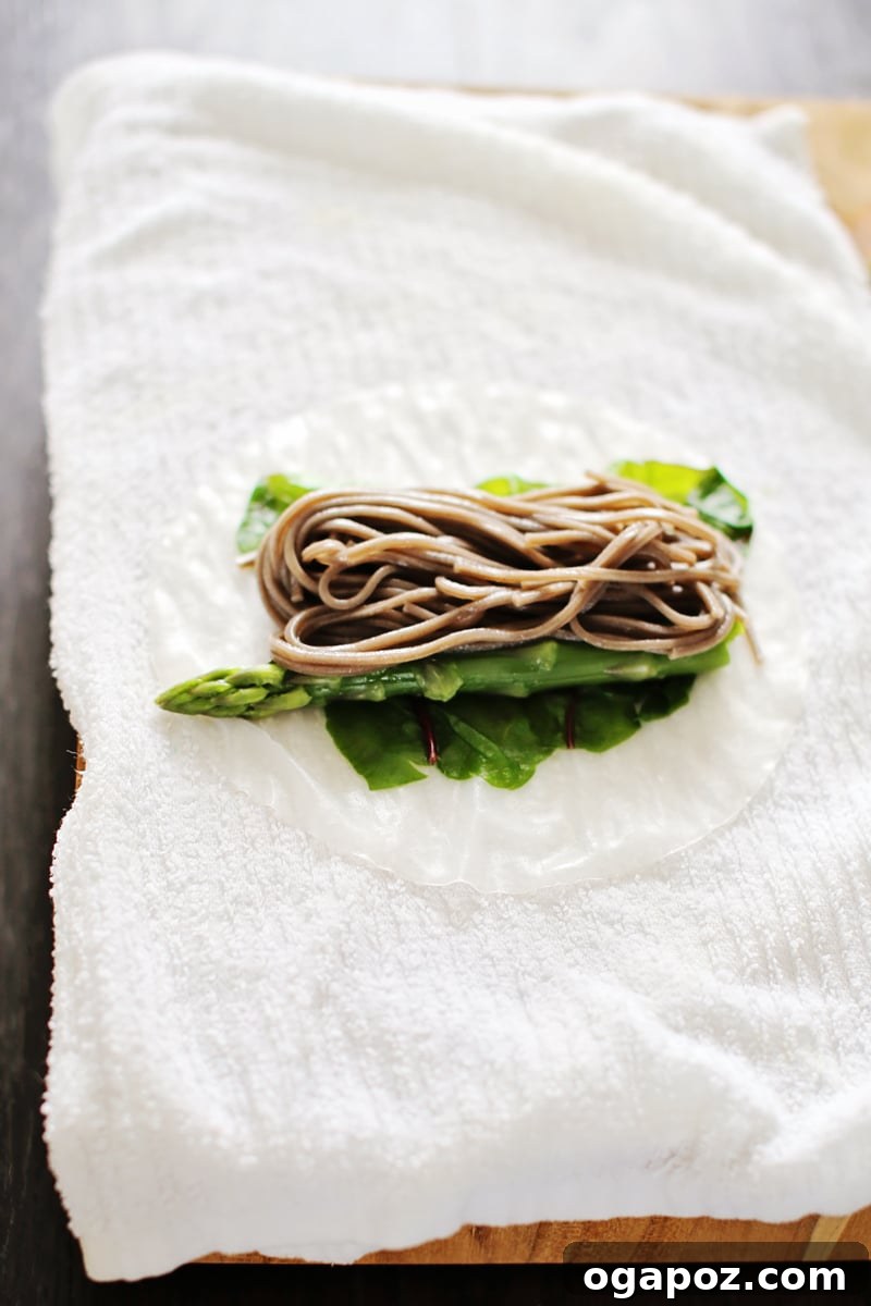 Asparagus, Chard and Soba Summer Rolls with Spicy Peanut Sauce 4 A platter of beautifully arranged homemade summer rolls with a bowl of peanut sauce.
