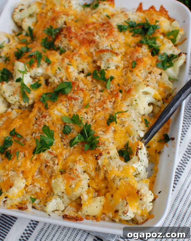 Baked Cheesy Cauliflower 6 A close-up of a serving spoon scooping into the rich and creamy Cauliflower Gratin, highlighting its texture and melted cheese.