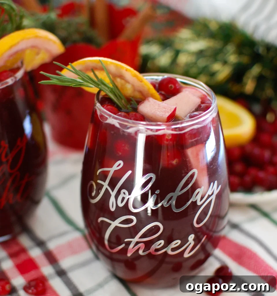 Holiday Cheer Sangria 2 Christmas Sangria with rosemary garnish, ready to serve